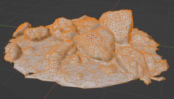 A photosanned pile of rocks decimated to 12,000 faces in Blender's 3D viewport.