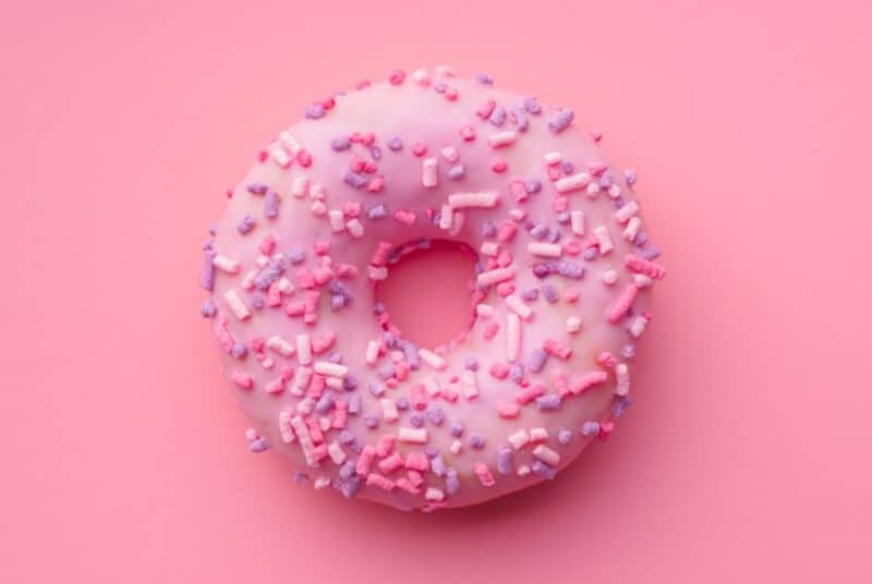 A pink sprinkled donut. 