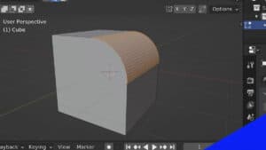 A default cube in Blender has an edge bevel applied to one edge in the 3D viewport.