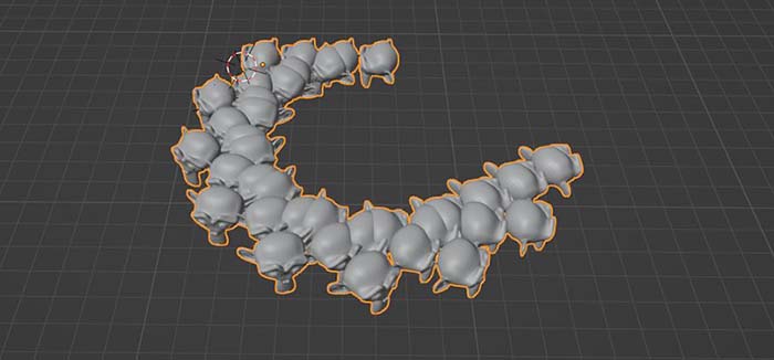 A suzanne monkey is arrayed in a row and then in a half circle in the Blender 3D viewport using two array modifiers.