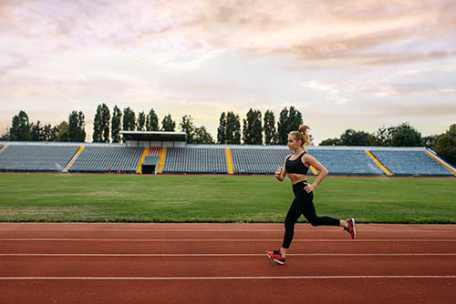 Woman running on sports track