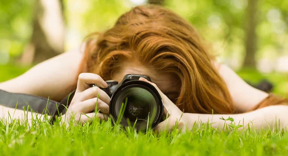 A close-up of a female photographer taking a photo. 