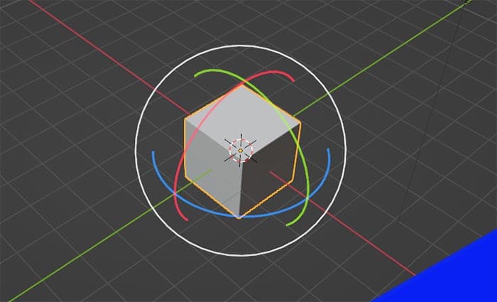 The Blender default cube has a rotation gizmo displayed around it. 